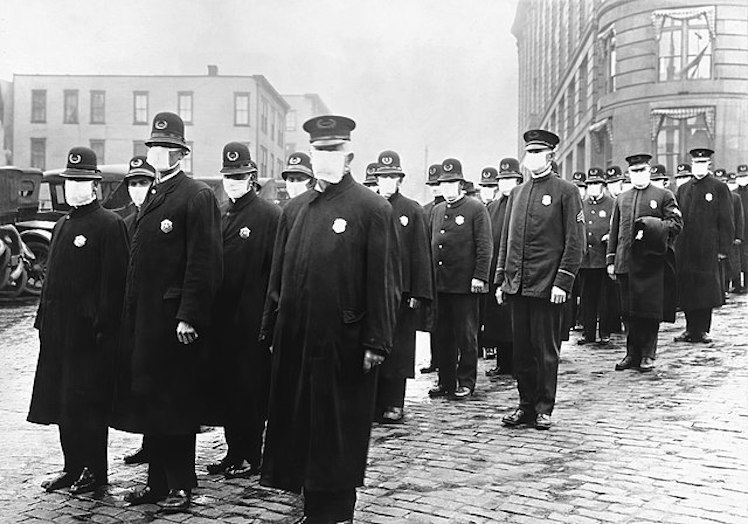 Policemen in Seattle wearing masks made by the Red Cross, during the influenza epidemic. December 1918.